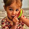 Destiny joined the competition — help win amazing prizes! toddler, child, toy_phone, strawberry_pattern, cute, indoor, portrait, cozy, blanket, curious, playful, young_child, person, face, head, sitting, clothing, soft_lighting, close_up, innocence