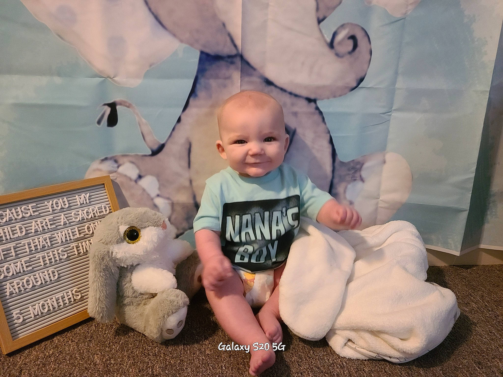 Everett joined the competition — help win amazing prizes! baby, baby_toddler_clothing, child, comfort, eye, flooring, fun, happy, joy, pattern, person, room, sitting, smile, stuffed_toy, t_shirt, toddler, vacation