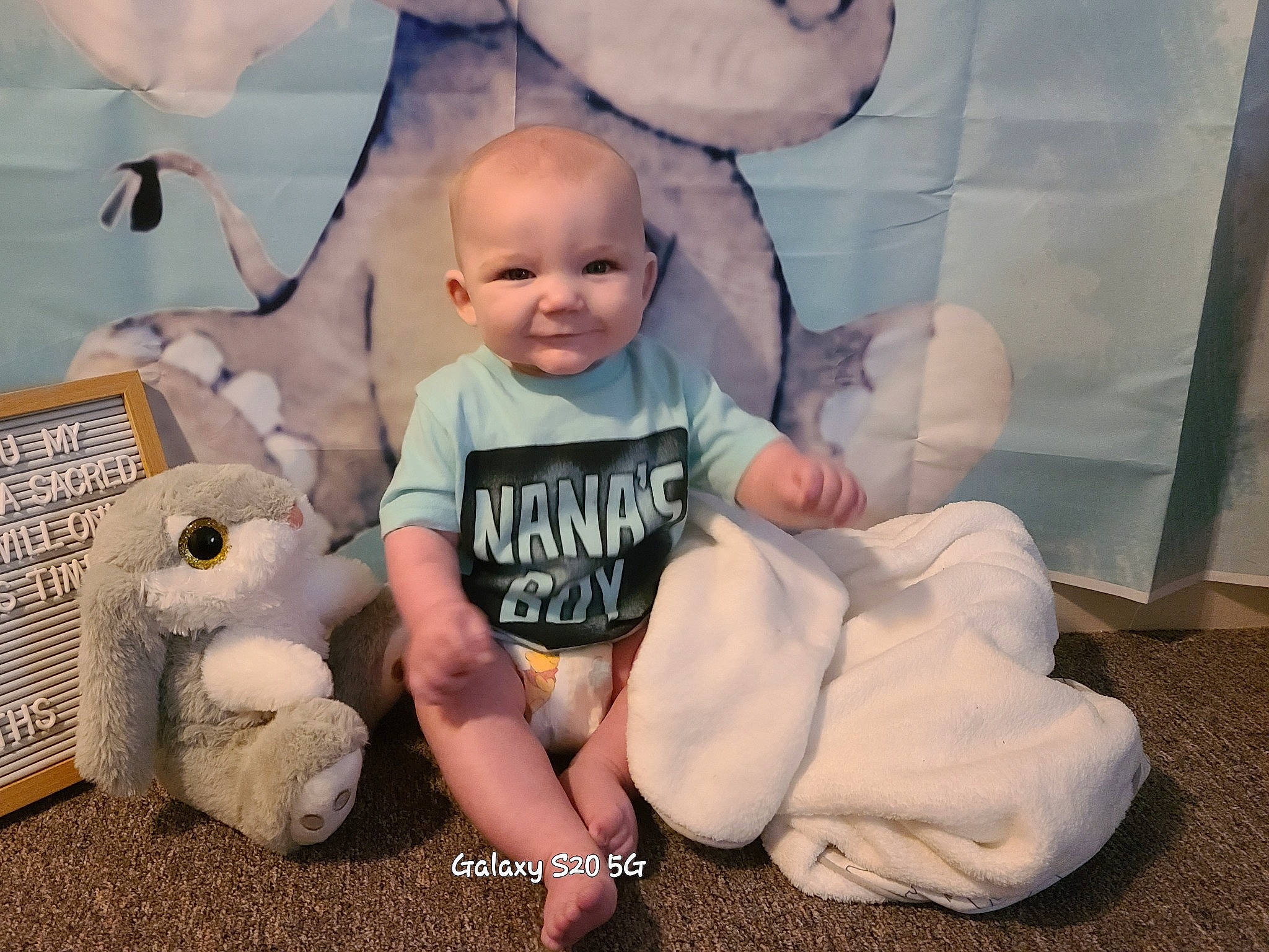 Everett is registered to the contest to win money with this photo: baby, baby_toddler_clothing, child, comfort, flash_photography, fun, happy, joy, person, portrait_photography, room, sitting, skin, sleeve, smile, stuffed_toy, t_shirt, toddler, toy
