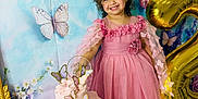 Gabriella joined the competition — help win amazing prizes! child, girl, birthday, cake, balloon, number_two, pink_dress, flower_crown, butterflies, decorations, smiling, happy, party, table, floral, background, indoor, curly_hair, footwear, celebration