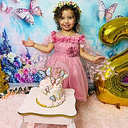 Gabriella joined the competition — help win amazing prizes! child, girl, birthday, cake, balloon, pink_dress, flower_crown, butterflies, floral_background, party, smiling, celebration, curly_hair, table, decorations, happy, indoors, portrait, cute, festive