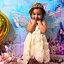 Gabriella joined the competition — help win amazing prizes! child, girl, birthday_cake, dress, tiara, fairy_wings, butterfly, flowers, pink, white_shoes, curly_hair, smiling, party, celebration, decorations, background, table, cake_topper, floral, indoor