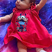 Eliora is registered to the contest to win money with this photo: baby, infant, child, red_dress, minnie_mouse, cartoon, raising_arm, lying_down, purple_blanket, stars, pattern, cute, adorable, clothing, footwear, soft_toys, portrait, smiling, young_child, indoor