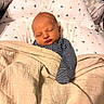 newborn, baby, sleeping, infant, portrait, blanket, swaddled, bed, pillow, cozy, indoors, striped_clothing, peaceful, resting, nursery, soft_lighting, close_up, face, head, home