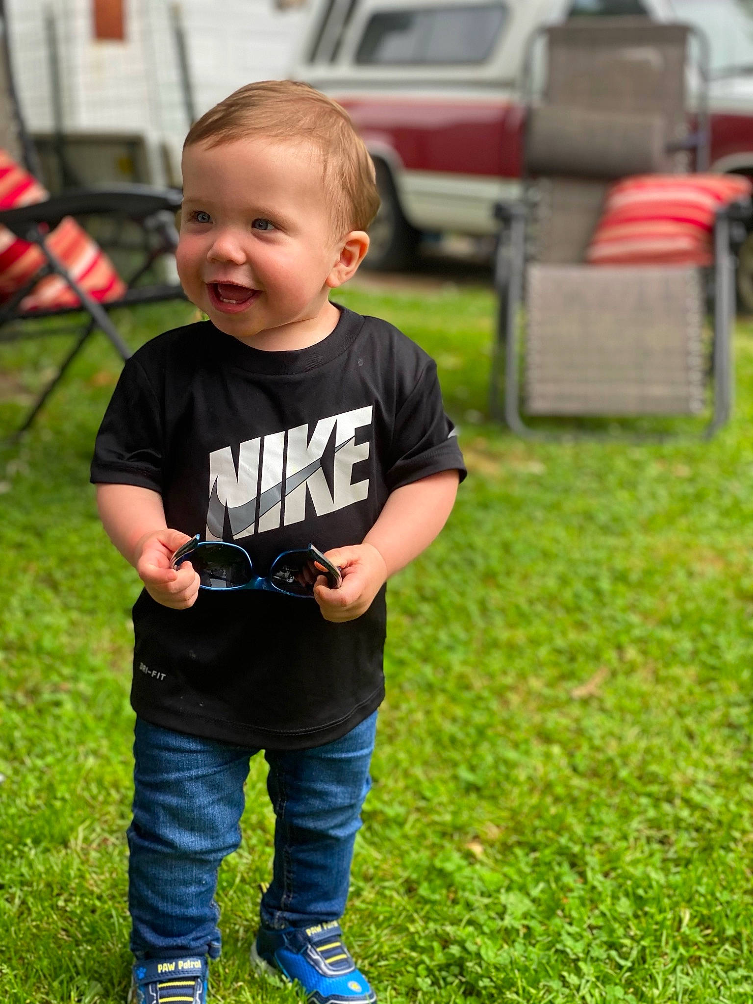Wesley is registered to the contest to win money with this photo: baby, car, child, denim, fun, garden, grass, happy, jeans, lawn, leisure, person, plant, play, recreation, sitting, smile, summer, t_shirt, toddler