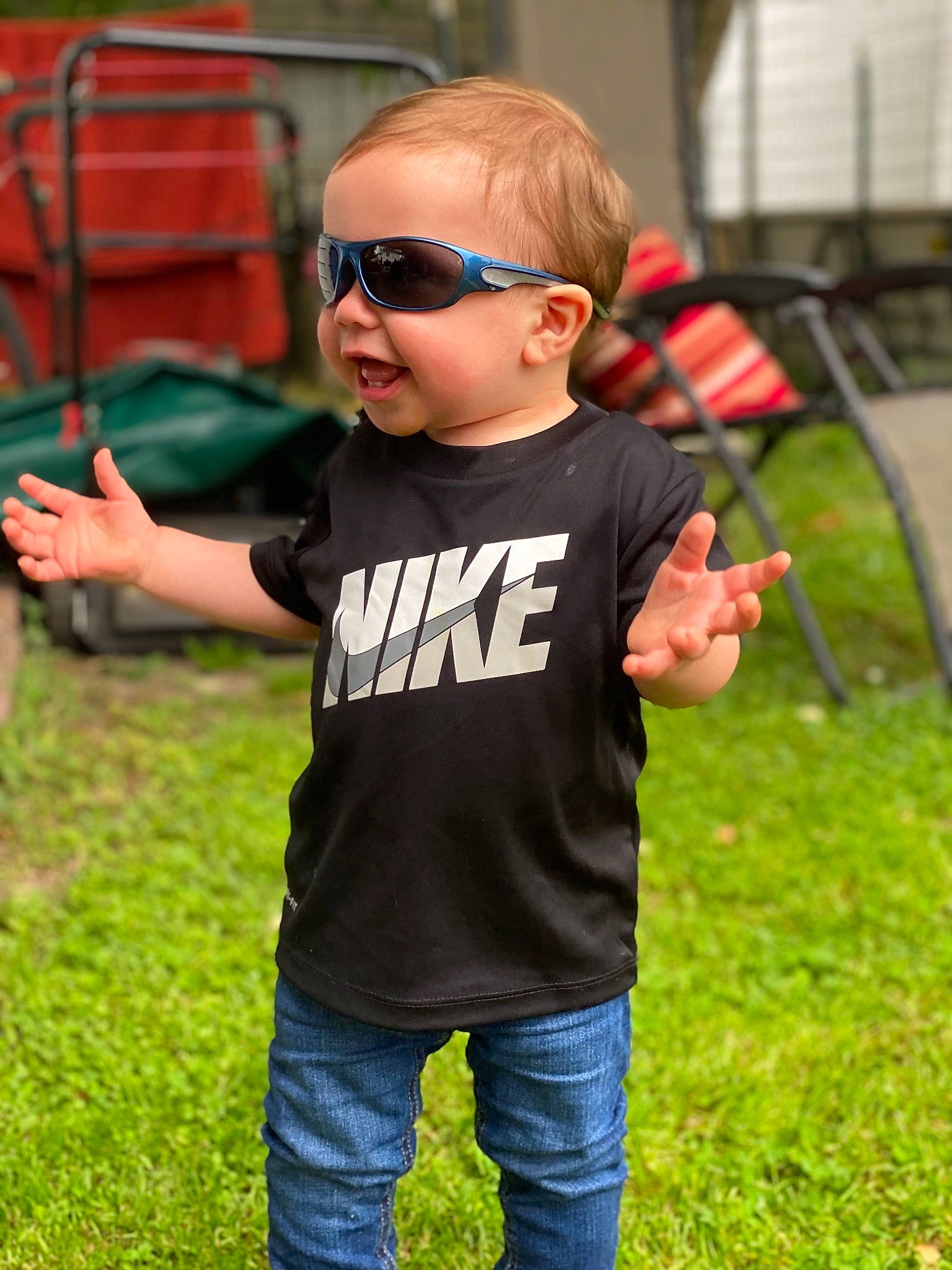 Wesley is registered to the contest to win money with this photo: cool, event, eyewear, finger, fun, gesture, goggles, grass, hand, happy, jeans, leisure, person, recreation, sleeve, street_fashion, summer, sunglasses, t_shirt, toddler