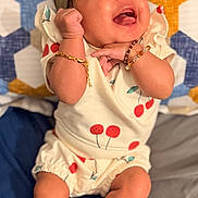 Azuri Howard is registered to the contest to win money with this photo: baby, bracelets, cherry_pattern, child, clothing, colorful_blanket, cute, expression, face, geometric_pattern, hand, happy, headband, infant, joyful, lying_down, person, skin, smiling, white_socks