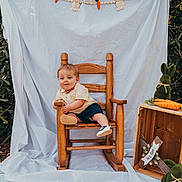 Elliot joined the competition — help win amazing prizes! baby, backdrop, bow_tie, child, crate, fabric, greenery, leaves, outdoor, photography, portrait, props, rocking_chair, shoes, sitting, smile, stuffed_bunny, toddler, toy_carrot, wooden_chair