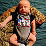 Dean is registered to the contest to win money with this photo: baby, bed, blanket, blue, camouflage, child, clothing, cute, footwear, hand, indoor, infant, lying_down, newborn, onesie, peaceful, portrait, skin, sleeping, sock