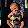Dean is registered to the contest to win money with this photo: baby, car_seat, pacifier, infant, child, seatbelt, yellow_clothing, barefoot, indoors, human, young_child, safety_harness, cute, relaxed, skin, head, legs, feet, hand, face