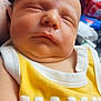 Dean is registered to the contest to win money with this photo: baby, sleeping, infant, yellow_clothing, white_clothing, face, closeup, peaceful, newborn, child, portrait, skin, nap, cute, indoors, soft_light, resting, person, sleeveless_shirt, mama