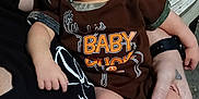 Dean joined the competition — help win amazing prizes! adult, arm, baby, casual, closeup, clothing, comfort, fabric, hand, holding, indoor, infant, onesie, person, portrait, resting, skin, sleepy, socks, tattoo