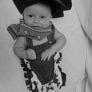 Dean is registered to the contest to win money with this photo: baby, baby_clothes, bandana, black_and_white, blanket, boots, clothing, costume, cowboy, cute, hat, infant, infant_fashion, lying_down, pattern, person, portrait, small_child, stars, stripes