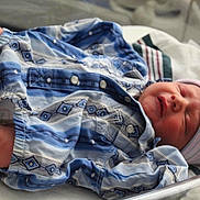 Dean joined the competition — help win amazing prizes! newborn, baby, infant, sleeping, hospital, bassinet, onesie, hat, foot, bracelet, blanket, bed, person, clothing, pattern, striped, blue, pink, hospital_room, peaceful