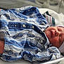 newborn, baby, infant, sleeping, hospital, bassinet, onesie, hat, foot, bracelet, blanket, bed, person, clothing, pattern, striped, blue, pink, hospital_room, peaceful