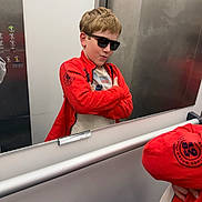 Ioane a rejoint le concours — aidez-le/la à gagner de superbes lots ! child, boy, sunglasses, red_jacket, mirror, reflection, elevator, pose, confident, casual_clothing, short_hair, indoor, young, standing, modern, smile, fashion, cool, hands_crossed, playful