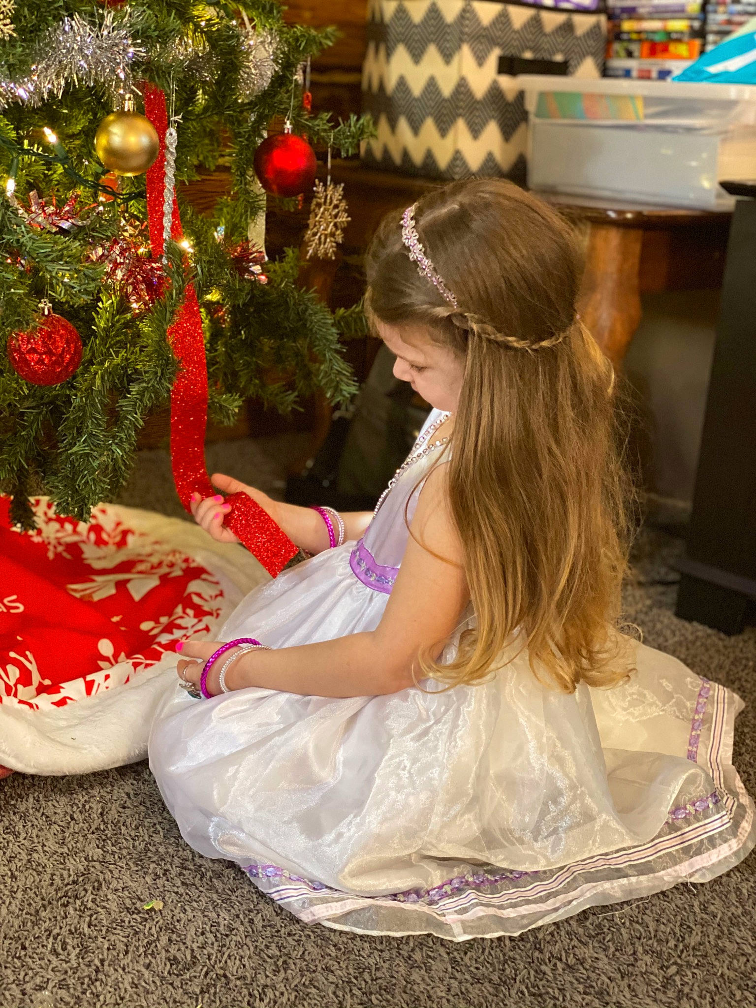 Savanna is registered to the contest to win money with this photo: child, christmas_decoration, christmas_ornament, christmas_tree, dress, embellishment, event, fashion_design, fun, hairstyle, happy, headpiece, holiday_ornament, jewellery, ornament, person, plant, tiara, toddler, toy