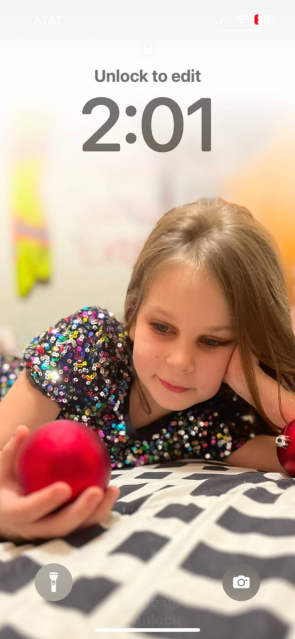 Savanna is registered to the contest to win money with this photo: carmine, child, comfort, facial_expression, food, fun, happy, holiday, human, linens, lip, nail, pattern, person, play, portrait_photography, room, sitting, sweetness, toy