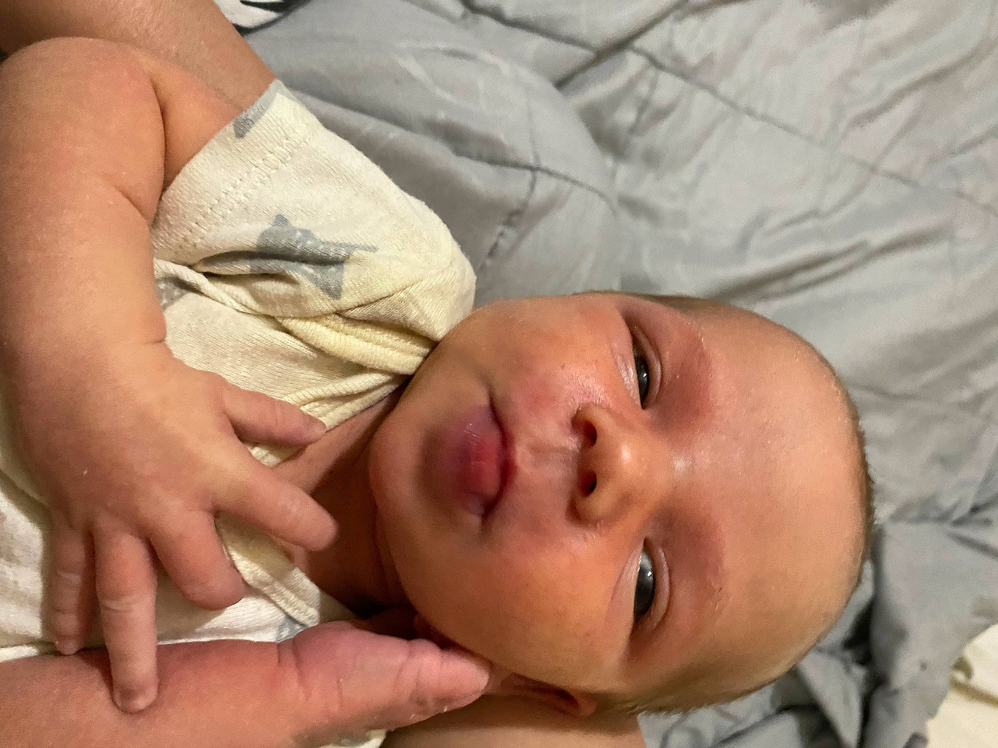 Kara is registered to the contest to win money with this photo: abdomen, baby, cheek, chest, child, comfort, elbow, eyebrow, eyelash, finger, gesture, happy, linens, lip, mouth, nail, nose, person, skin, thumb