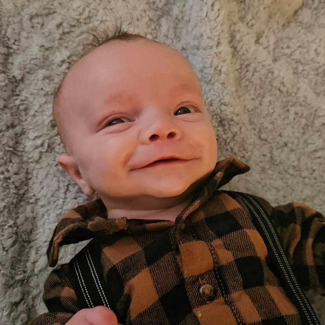 Hudson is registered to the contest to win money with this photo: baby, bodypart, clothing, coat, face, finger, fleece, hand, happy, head, hood, hoodie, knitwear, newborn, person, photography, portrait, smile, sweater, sweatshirt