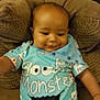 baby, infant, 6_months_old, cookie_monster, blue_clothing, smiling, cushion, chair, milestone_card, indoor, portrait, cute, child, happy, sitting, plush, face, person, head, patterned_clothing