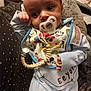 baby, infant, pacifier, bib, mickey_mouse, clothing, pajamas, blanket, resting, soft_texture, cute, child, indoors, person, face, hand, expression, comfort, sleepwear, toy