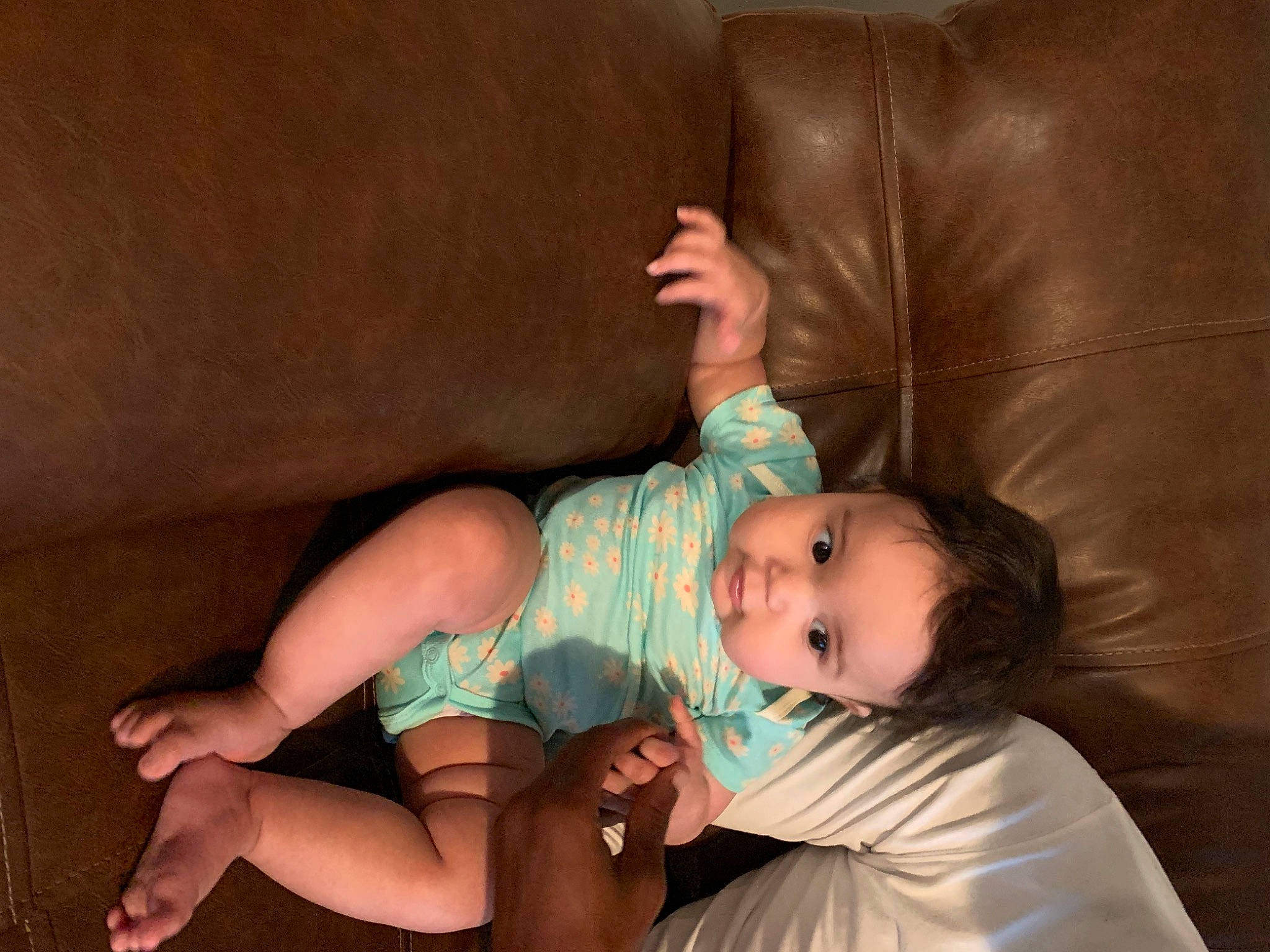 Leanna is registered to the contest to win money with this photo: arm, baby, black_hair, child, finger, foot, hand, human_body, human_leg, joint, leg, mouth, neck, pantyhose, person, sitting, thigh, thumb, toddler