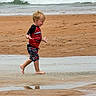 Aster is registered to the contest to win money with this photo: child, toddler, beach, sand, ocean, waves, water, running, barefoot, clothing, red_shirt, shorts, happy, playful, outdoor, summer, vacation, youth, nature, coast