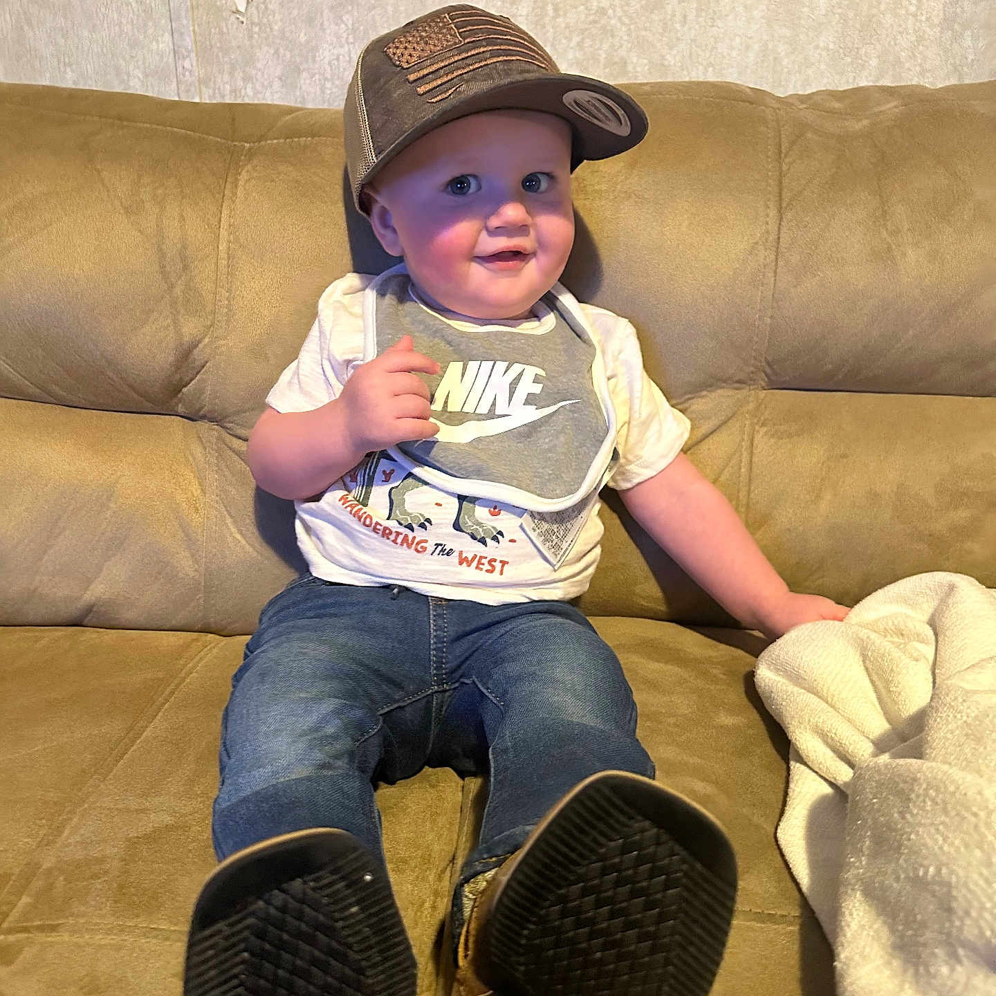 Aster is registered to the contest to win money with this photo: baby, baseballcap, cap, clothing, couch, cushion, electricaldevice, face, footwear, furniture, hat, head, homedecor, jeans, pants, person, photography, portrait, shoe, sitting