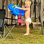 Aster is registered to the contest to win money with this photo: toddler, child, diaper, swing, blue_swing, outdoor, grass, barefoot, wooden_fence, sunlight, play, baby, fence, chair, red_swing, yellow_rope, person, young_child, summer, backyard