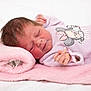 baby, baby_clothing, cartoon_character, child, closeup, cozy, cute, indoors, infant, lavender_onesie, lying_down, newborn, peaceful, pink_blanket, portrait, resting, sleep, sleeping, soft_texture, towel