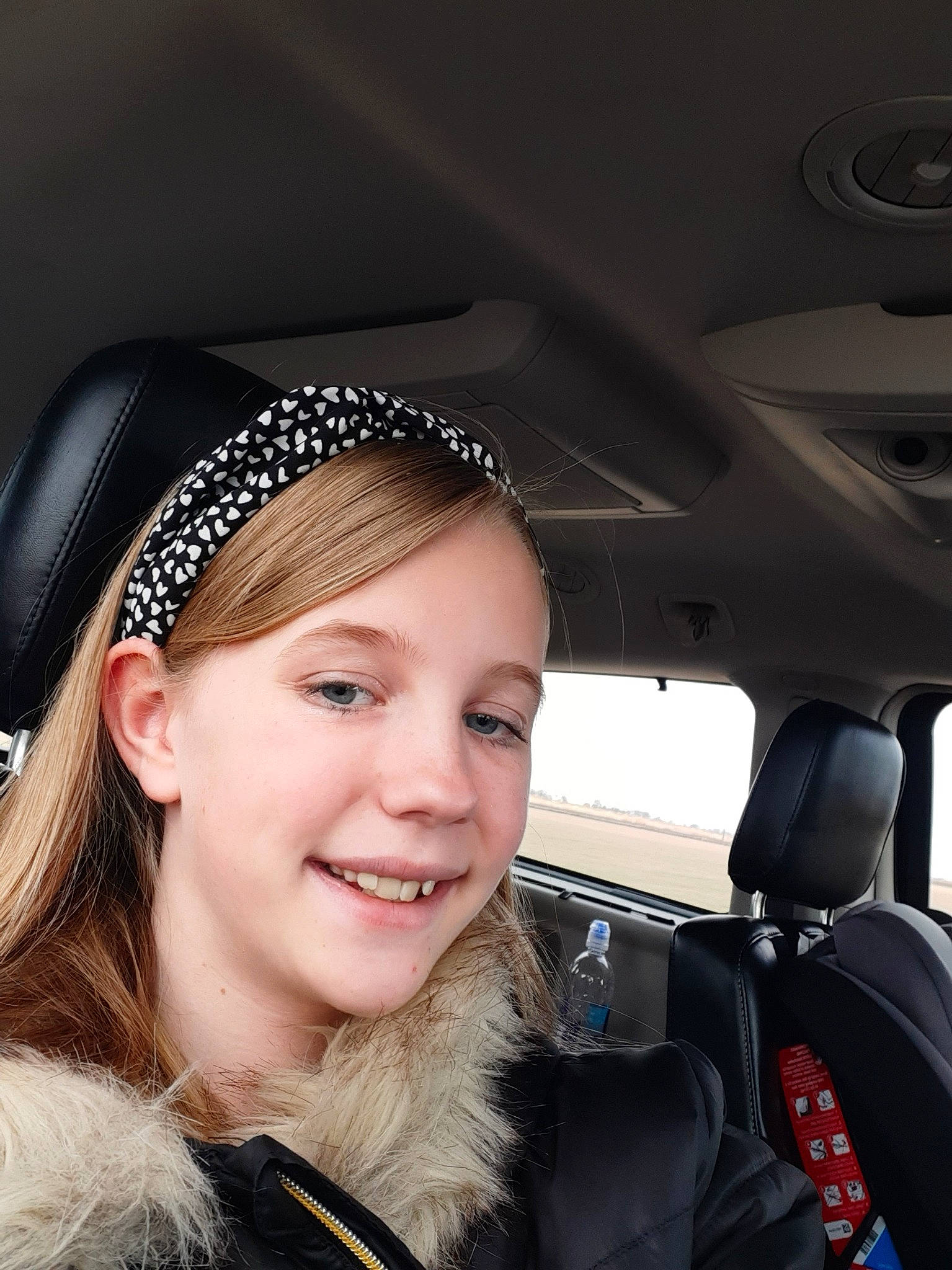 Rayne is registered to the contest to win money with this photo: auto_part, black_hair, car, eyewear, face, facial_expression, family_car, fashion_accessory, fun, hair, hair_accessory, hat, head, headgear, joy, lip, long_hair, person, photography, selfie