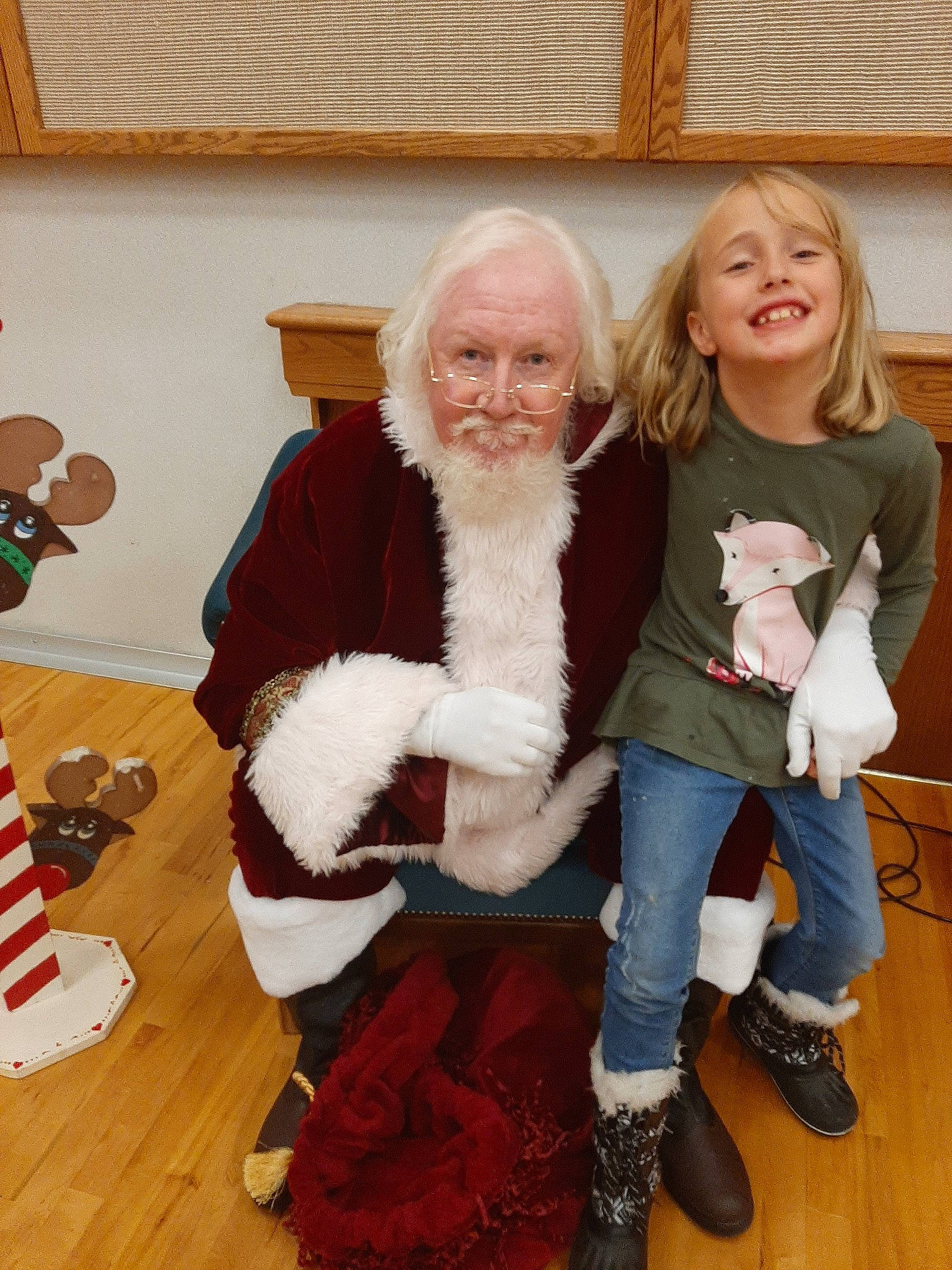 Kora joined the competition — help win amazing prizes! child, christmas, christmas_eve, christmas_tree, family, fictional_character, fur, holiday, joy, lap, person, santa_claus, sitting, toddler, wool