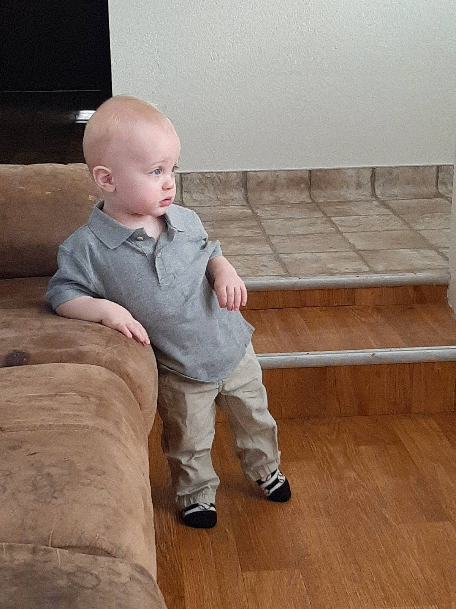 Kelton is registered to the contest to win money with this photo: cheek, child, finger, floor, flooring, leg, person, sitting, standing, toddler, wood