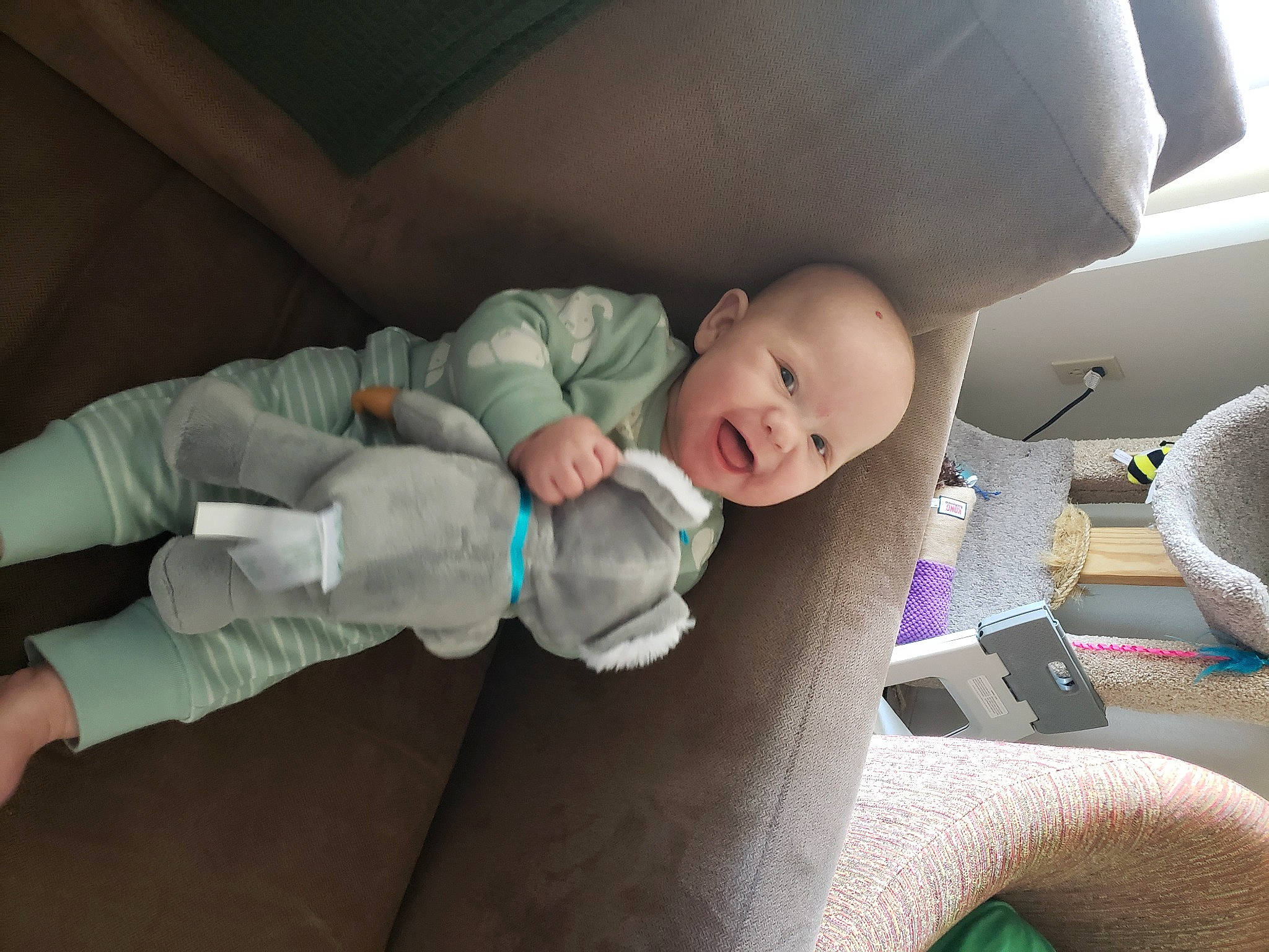 Ash is registered to the contest to win money with this photo: baby, baby_products, baby_toddler_clothing, car_seat, cheek, child, comfort, eye, face, finger, human_body, leg, linens, mouth, person, room, sitting, skin, smile, toddler