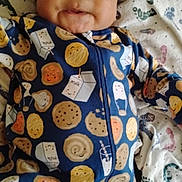 Ja'Kariyon is registered to the contest to win money with this photo: baby, child, infant, onesie, cookie_pattern, milk_carton_pattern, blanket, face, smile, cute, indoor, lying_down, clothing, curly_hair, soft_toys, portrait, young_child, sleepwear, comfort, playful