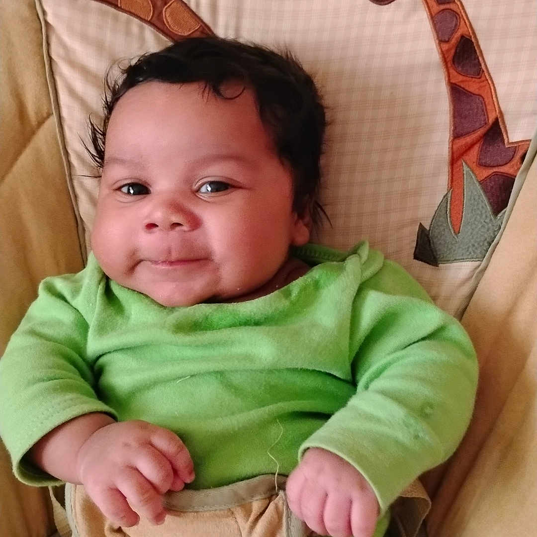 Ja'Kariyon joined the competition — help win amazing prizes! baby, baby_chair, child, comfortable, cushion, cute, face, giraffe_pattern, green_clothing, hands, happy, indoors, infant, legs, plush, portrait, seated, smiling, soft_fabric, turtle_patch