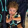 Bennett joined the competition — help win amazing prizes! baby, blue_eyes, casual, child, clothing, curly_hair, cute, expression, floor, hands, indoor, infant, person, playful, portrait, seatbelt, sitting, stroller, toddler, young
