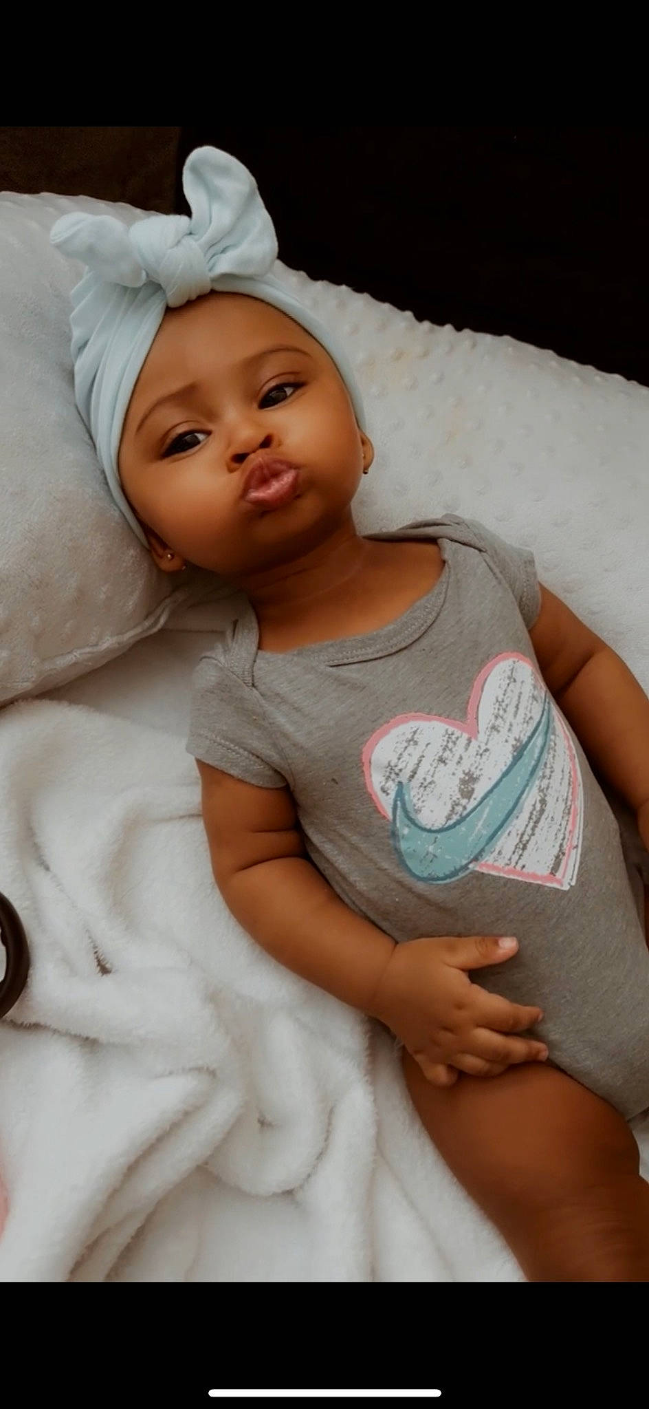 Aaleyah is registered to the contest to win money with this photo: arm, baby, baby_toddler_clothing, cap, cheek, comfort, eye, face, finger, gesture, happy, head, headwear, lip, mouth, nose, person, pink, skin, sleeve