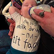 Theo joined the competition — help win amazing prizes! baby, bottle, child, closeup, clothing, cute, feeding, hand, humor, indoor, infant, milk, onesie, person, relaxation, resting, rings, sleeping, soft_lighting, text