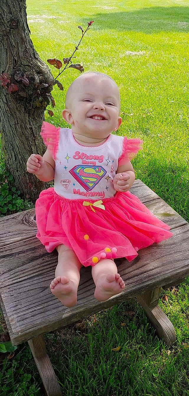 Aryianna joined the competition — help win amazing prizes! baby, baby_products, baby_toddler_clothing, child, dress, grass, joy, person, pink, product, sitting, smile, toddler