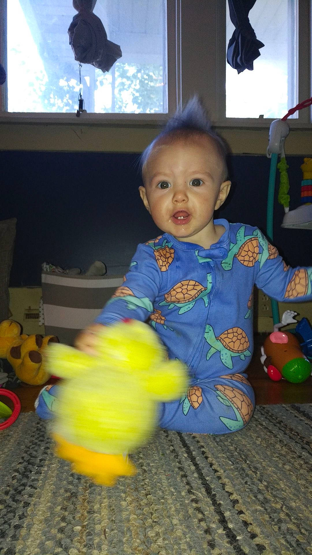 Jackson is registered to the contest to win money with this photo: baby, baby_products, baby_toddler_clothing, baby_toys, cheek, child, display_device, floor, flooring, fun, lamp, person, play, room, sitting, toddler, toy, wood