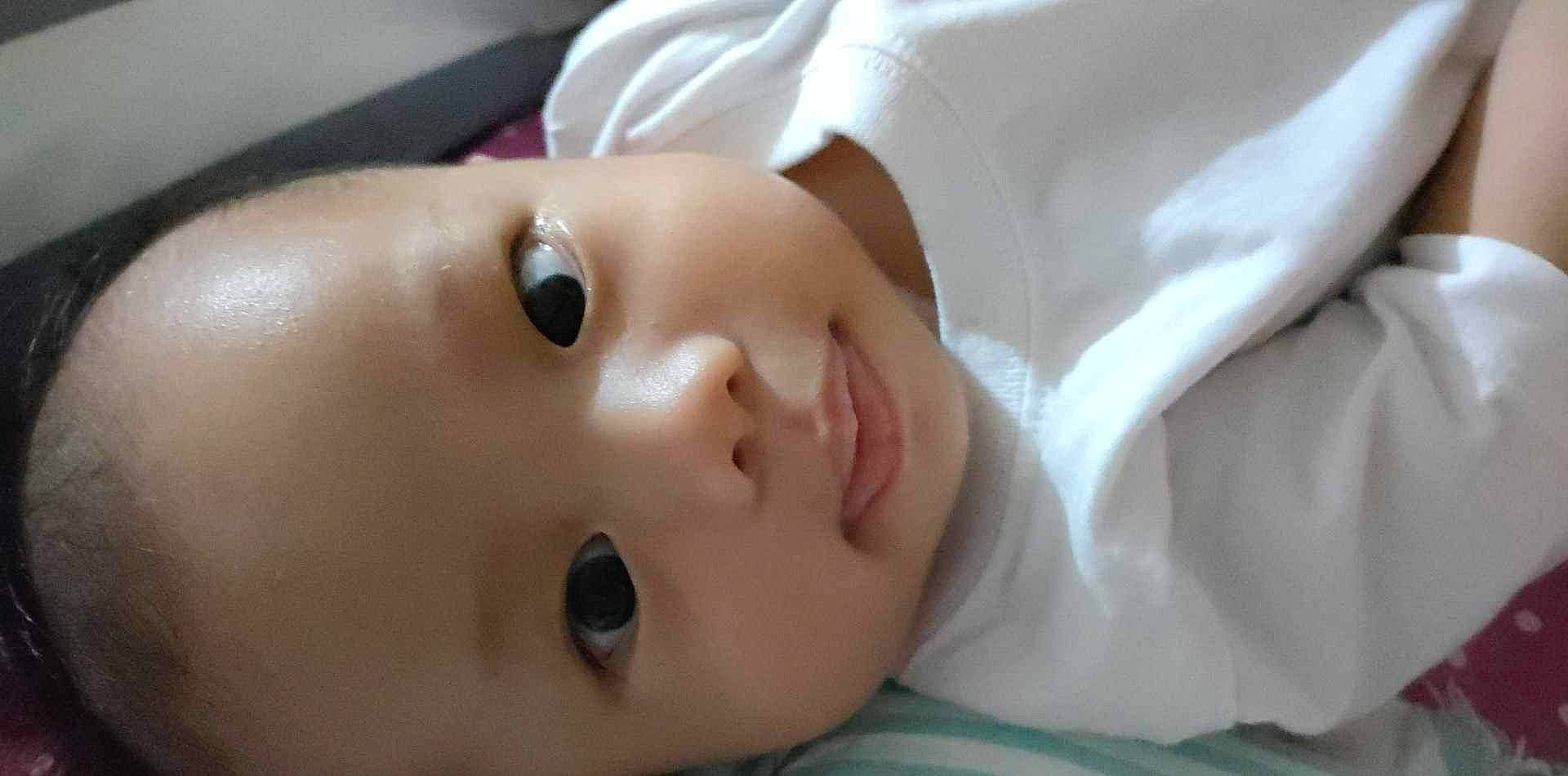 Eli is registered to the contest to win money with this photo: baby, baby_toddler_clothing, cheek, child, close_up, comfort, eyebrow, eyelash, hat, iris, lip, no_expression, nose, person, portrait_photography, skin, toddler