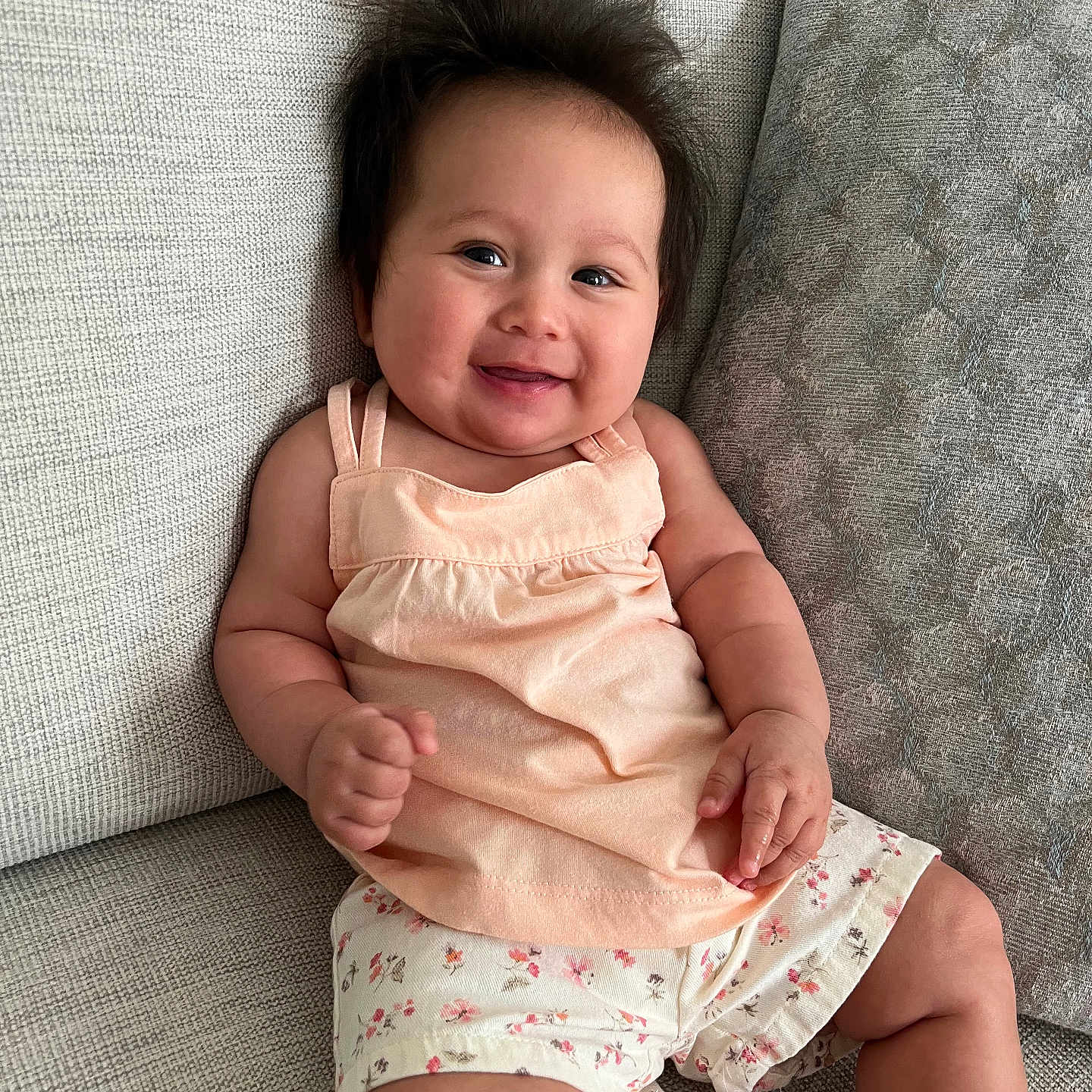 Ella joined the competition — help win amazing prizes! baby, babylaughing, bodypart, clothing, couch, cushion, face, finger, furniture, hand, happy, head, homedecor, laughing, person, photography, portrait, shorts, sitting, smile