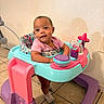baby, child, cute, face, floor, happy, indoor, infant, person, pink, play, purple, seat, smiling, socks, tile, toy, turquoise, walker, young