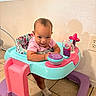 Justice joined the competition — help win amazing prizes! baby, blue, child, cute, footwear, happy, indoor, infant, leaning, person, pink, plastic, play, purple, seat, smiling, socks, tiled_floor, toy, walker