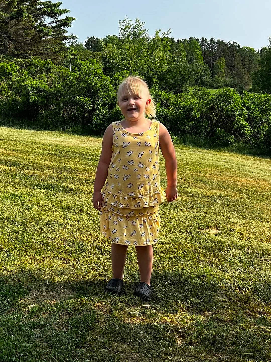 Kim is registered to the contest to win money with this photo: day_dress, fawn, gesture, grass, grassland, happy, human_body, joy, landscape, lawn, leisure, meadow, one_piece_garment, people_in_nature, person, plant, prairie, sky, sleeve, smile