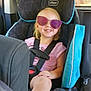 Selena joined the competition — help win amazing prizes! child, car_seat, sunglasses, smiling, blonde_hair, seatbelt, car_interior, casual_clothing, pink_shirt, happy, sitting, young_girl, safety, road_trip, footwear, window, daylight, vehicle, kid, seat