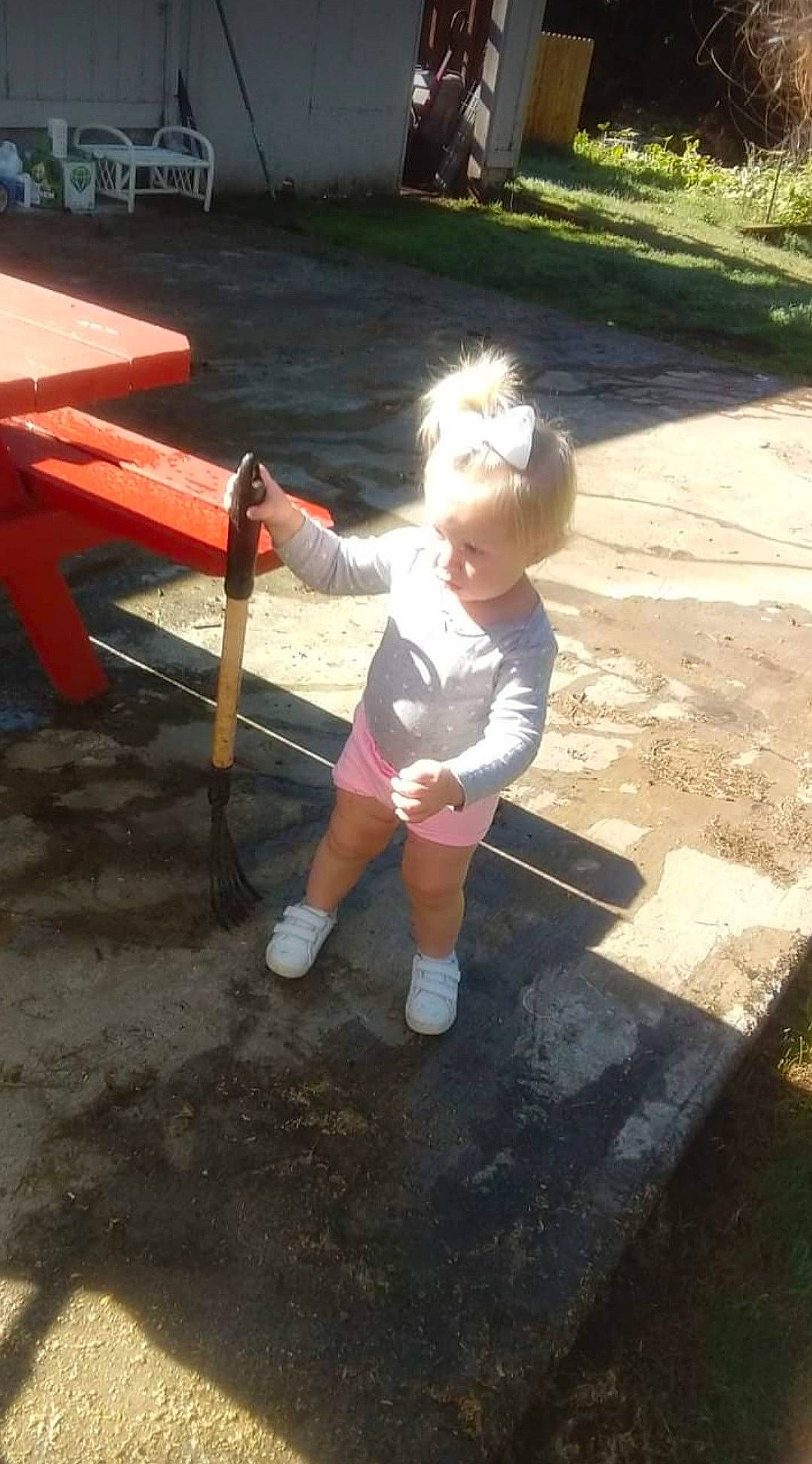 Nalani is registered to the contest to win money with this photo: asphalt, child, city, concrete, driveway, fun, grass, leisure, outdoor_play_equipment, person, play, recreation, road_surface, shade, shadow, shorts, sitting, soil, t_shirt, toddler