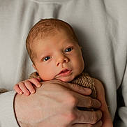 Waylon joined the competition — help win amazing prizes! newborn, baby, hand, adult, knitted_clothing, closeup, portrait, skin, face, eyes, fingers, warmth, cozy, caring, tenderness, soft_lighting, indoor, person, sweater, holding